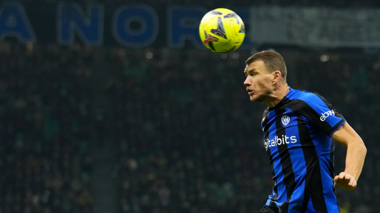 Inter Milan's Edin Dzeko heads the ball during a Serie A soccer match between Inter Milan and Hellas Verona at the San Siro stadium in Milan, Italy, Saturday, Jan. 14, 2023. (AP)