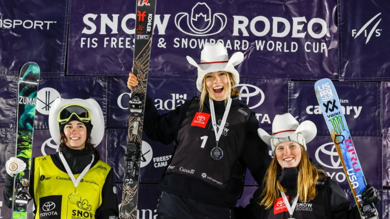 China's Ailing Eileen Gu, centre, celebrates her victory with second place finisher Canada's Rachael Karker, left, and third place finisher Hanna Faulhaber, of the United States, on podium following the women's World Cup freestyle ski halfpipe event in Calgary, Alta., Thursday, Jan. 19, 2023. (Jeff McIntosh/CP)