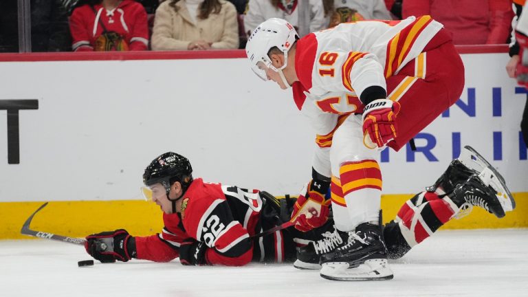 Chicago Blackhawks left wing Brett Seney, left, falls on the stick of Calgary Flames defenseman Nikita Zadorov during the first period of an NHL hockey game Sunday, Jan. 8, 2023, in Chicago. (Erin Hooley/AP)