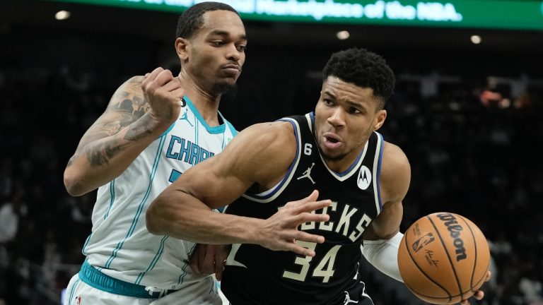 Milwaukee Bucks' Giannis Antetokounmpo drives past Charlotte Hornets' P.J. Washington during the second half of an NBA basketball game Tuesday, Jan. 31, 2023, in Milwaukee. The Bucks won 124-115. (Morry Gash/AP)