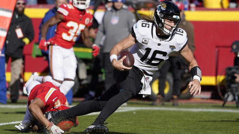 Jacksonville Jaguars quarterback Trevor Lawrence (16) runs with the ball as Kansas City Chiefs safety Bryan Cook (6) defends during the first half of an NFL football game Sunday, Nov. 13, 2022, in Kansas City, Mo. (Ed Zurga/AP)