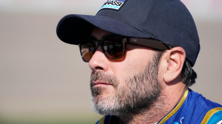 Jimmie Johnson stands near his car during qualifying for an IndyCar Series auto race, Saturday, July 23, 2022, at Iowa Speedway in Newton, Iowa. (Charlie Neibergall/AP)