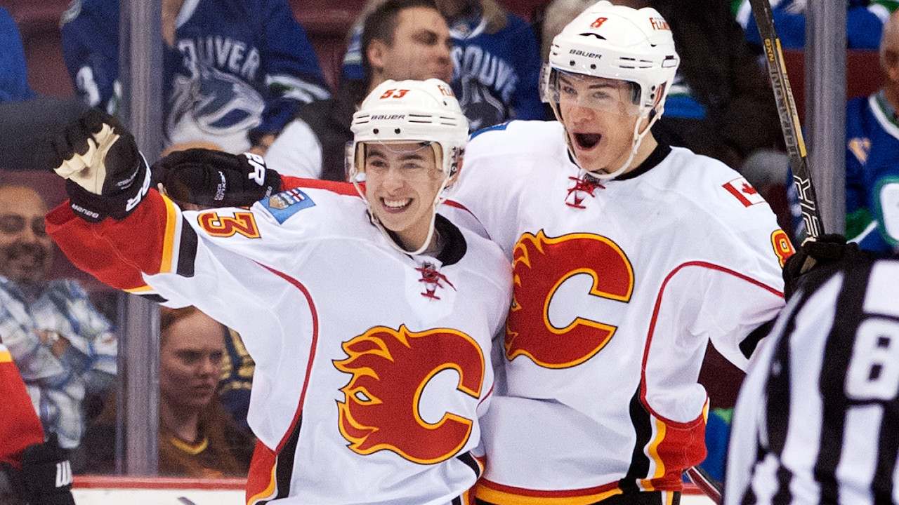 Johnny Gaudreau celebrates with teammate Joe Colborne after scoring his first NHL goal against the Vancouver Canucks during the second period in NHL action on April 13, 2014 at Rogers Arena in Vancouver. (Rich Lam/Getty Images)