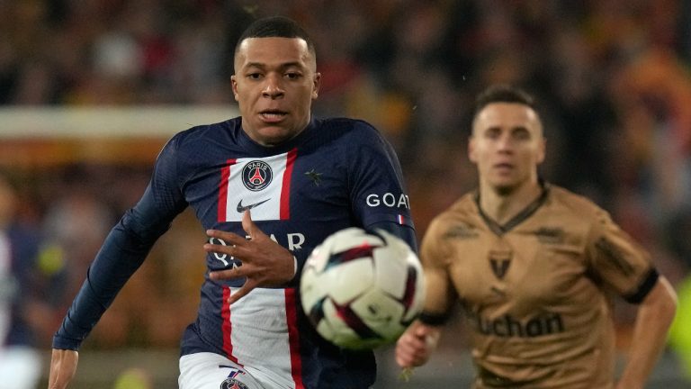 PSG's Kylian Mbappe races after the ball during the French League One soccer match between Lens and Paris Saint-Germain at the Bollaert stadium in Lens, France Sunday, Jan. 1, 2023 (Thibault Camus/AP)