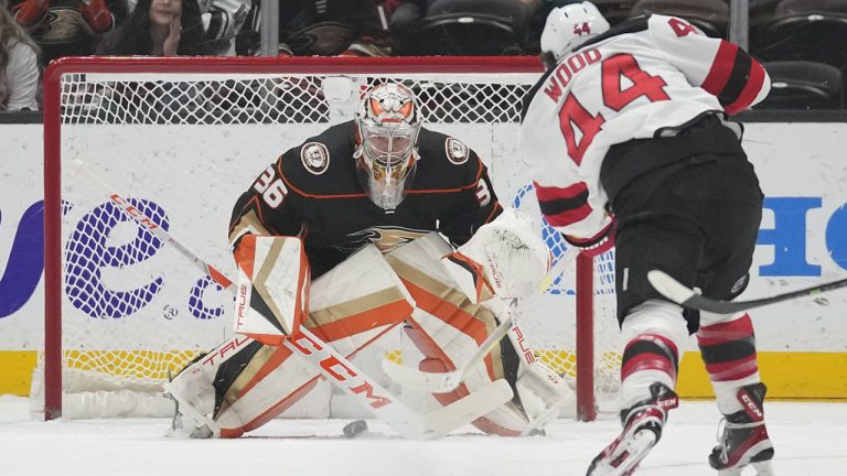 Anaheim Ducks goaltender John Gibson (36) stops a shot by New Jersey Devils left wing Miles Wood (44) during the first period of an NHL hockey game in Anaheim, Calif., Friday, Jan. 13, 2023. (Ashley Landis/AP)