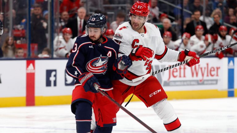 Columbus Blue Jackets forward Johnny Gaudreau, left, works for the puck in front of Carolina Hurricanes forward Max Pacioretty during the first period of an NHL hockey game in Columbus, Ohio, Saturday, Jan. 7, 2023. (Paul Vernon/AP)