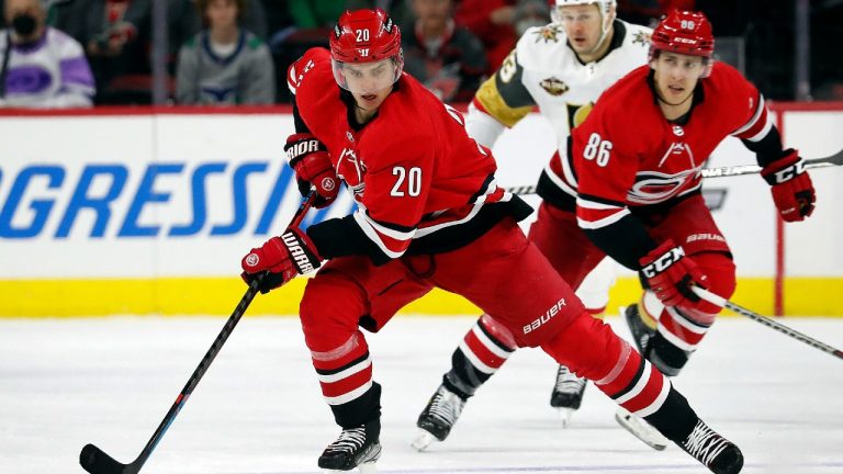 Carolina Hurricanes' Sebastian Aho (20) skates the puck up the ice with teammate Teuvo Teravainen (86) trailing on the play during the second period of an NHL hockey game against the Vegas Golden Knights in Raleigh, N.C., Tuesday, Jan. 25, 2022. (Karl B DeBlaker/AP)