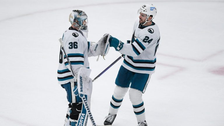 San Jose Sharks goalie Kaapo Kahkonen (36) celebrates with teammate Jaycob Megna (24) after defeating the Chicago Blackhawks 5-2 in an NHL hockey game, Sunday, Jan. 1, 2023, in Chicago. (Paul Beaty/AP)