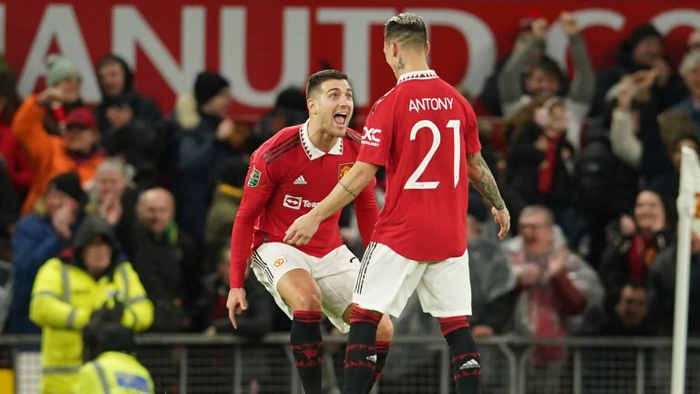 Manchester United's Antony, right, celebrates with Diogo Dalot after scoring the opening goal during the English League Cup quarter final soccer match between Manchester United and Charlton Athletic at Old Trafford in Manchester, England, Tuesday, Jan. 10, 2023. (Dave Thompson/AP)