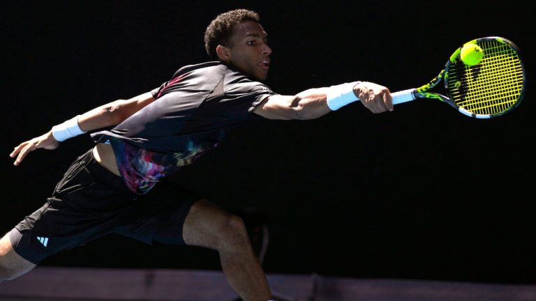 Felix Auger-Aliassime of Canada plays a backhand return to Francisco Cerundolo of Argentina during their third round match at the Australian Open tennis championship in Melbourne, Australia, Friday, Jan. 20, 2023. (Ng Han Guan/AP)