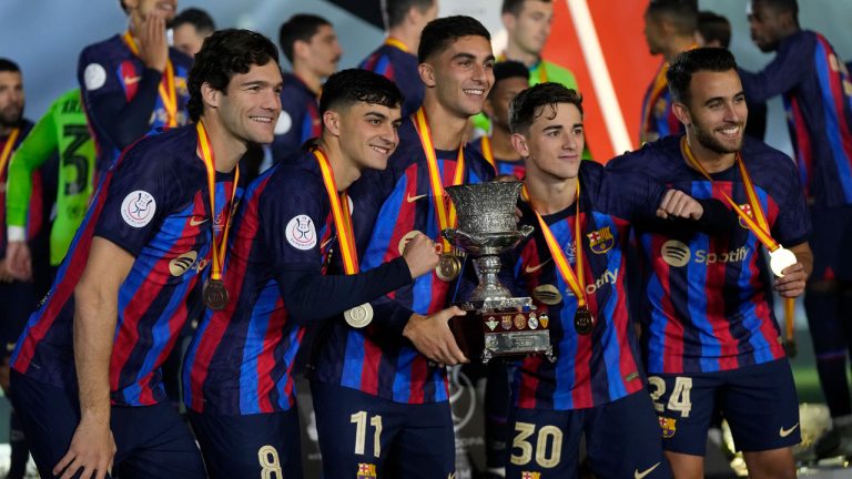 Barcelona players celebrate with a trophy after the won the final of the Spanish Super Cup between Barcelona and Real Madrid. (Hussein Malla/AP)