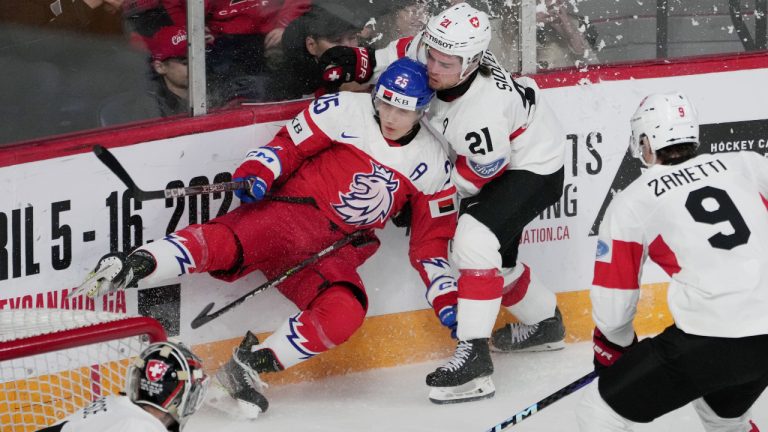 Czechia’s Jiri Kulich, left, is checked into the boards by Switzerland’s Dario Sidler during first period IIHF World Junior Hockey Championship quarterfinal action in Halifax on Monday, January 2, 2023. (Darren Calabrese/CP)