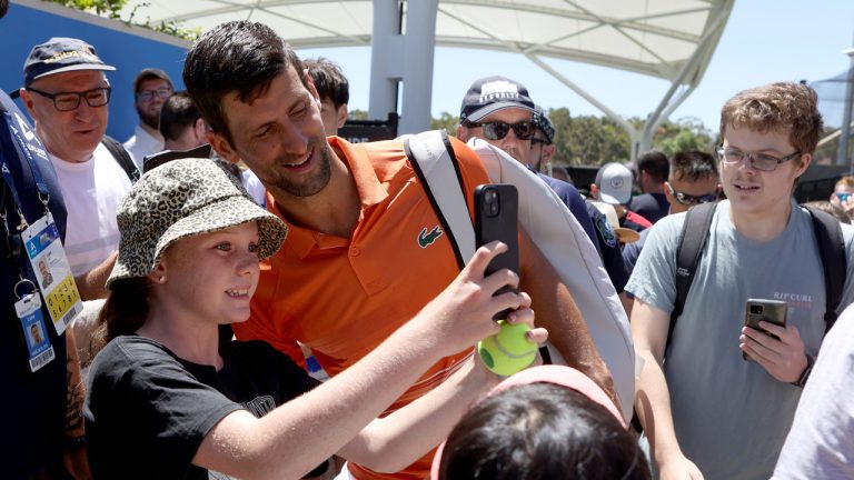 Serbia's Novak Djokovic, center, interacts with fans after his doubles match at the Adelaide International Tennis tournament. (Kelly Barnes/AP)