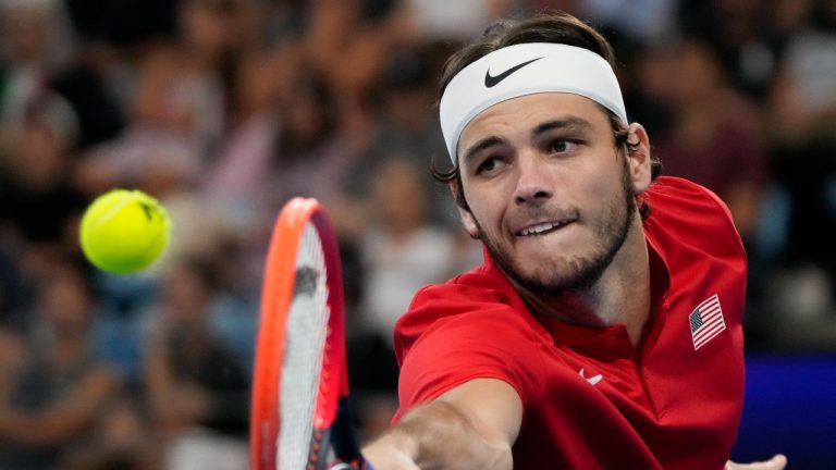 United States' Taylor Fritz plays a backhand return to Italy's Matteo Berrettini during the final of the United Cup tennis event in Sydney, Australia, Sunday, Jan. 8, 2023. (Mark Baker/AP)