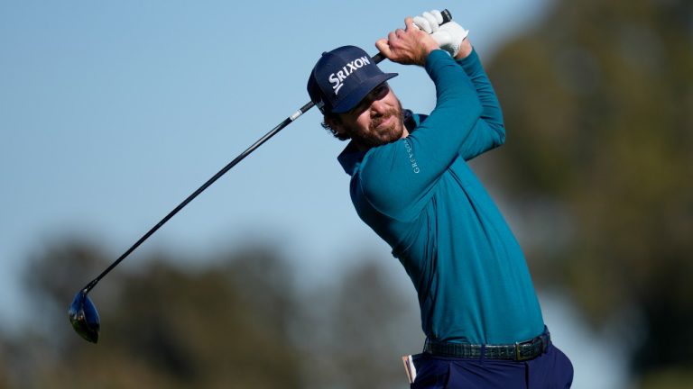 Sam Ryder hits his tee shot on the 18th hole of the North Course at Torrey Pines during the first round of the Farmers Insurance Open golf tournament, Wednesday, Jan. 25, 2023, in San Diego. (Gregory Bull/AP Photo)