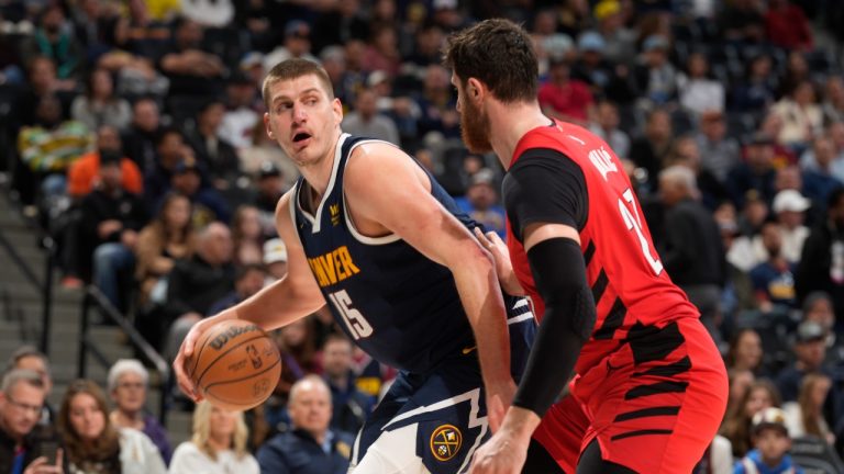 Denver Nuggets center Nikola Jokic, left, is defended by Portland Trail Blazers center Jusuf Nurkic during the second half of an NBA basketball game Tuesday, Jan. 17, 2023, in Denver. (David Zalubowski/AP)