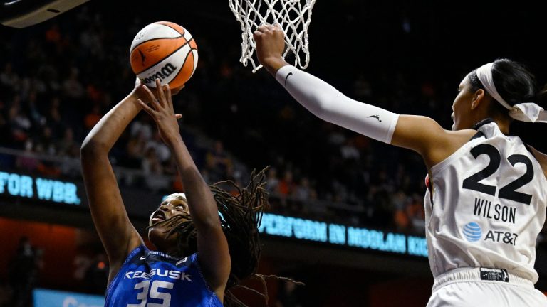 Connecticut Sun's Jonquel Jones shoots as Las Vegas Aces' A'ja Wilson, right, defends during the first half in Game 3 of basketball's WNBA Finals, Thursday, Sept. 15, 2022, in Uncasville, Conn.