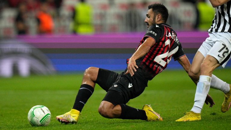 Nice's Gaetan Laborde, left, kicks the ball ahead of Partizan's Slobodan Urosevic during the Conference League Group D soccer match between Nice and Partizan at Allianz Riviera stadium in Nice, France, Thursday, Oct. 27, 2022. (Daniel Cole/AP)