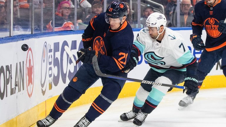 Seattle Kraken' Jordan Eberle (7) and Edmonton Oilers' Klim Kostin (21) battle for the puck during first period NHL action in Edmonton on Tuesday, January 3, 2023. (Jason Franson/THE CANADIAN PRESS)