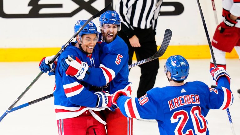 New York Rangers' K'Andre Miller (79) celebrates with Ben Harpur (5) and Chris Kreider (20) after scoring a goal during the third period of an NHL hockey game against the Carolina Hurricanes Tuesday, Jan. 3, 2023, in New York. The Rangers won 5-3. (Frank Franklin II/AP Photo)