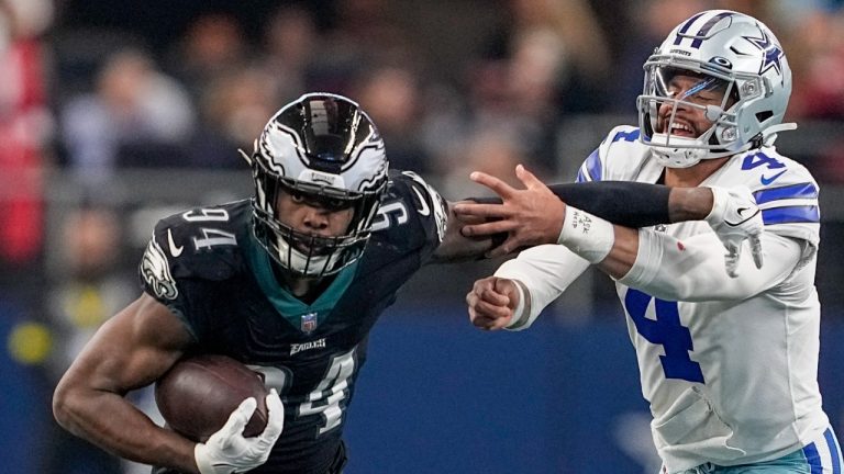 Philadelphia Eagles' Josh Sweat intercepts a pass by Dallas Cowboys' Dak Prescott and returns it for a touchdown during the first half of an NFL football game Saturday, Dec. 24, 2022, in Arlington, Texas. (Tony Gutierrez/AP)