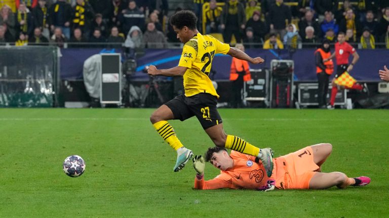 Dortmund's Karim Adeyemi is about to score his side's first goal jumping over Chelsea's goalkeeper Kepa Arrizabalaga during the Champions League, round of 16, first leg soccer match between Borussia Dortmund and Chelsea FC in Dortmund, Germany, Wednesday, Feb. 15, 2023. (Martin Meissner/AP)