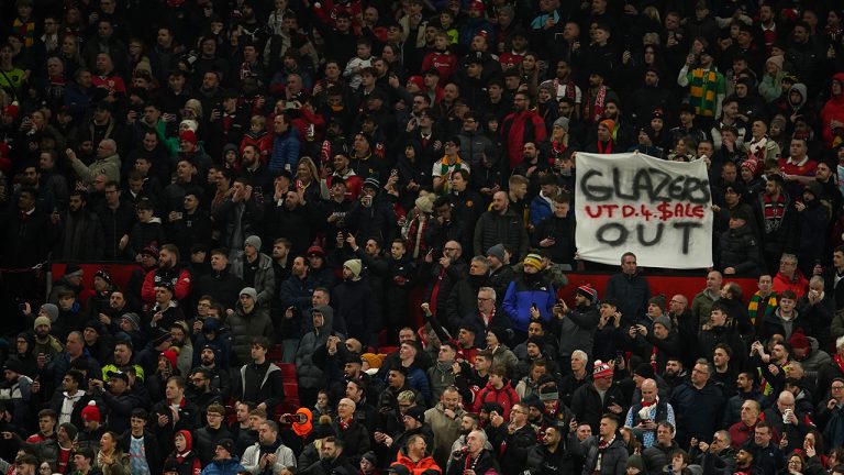 An anti-Glazer family banner is held up by members of the crowd before the English League Cup semifinal second leg soccer match between Manchester United and Nottingham Forest at Old Trafford in Manchester, England, Wednesday, Feb. 1, 2023. The Glazer family are the owners of Manchester United. (Dave Thompson/AP)