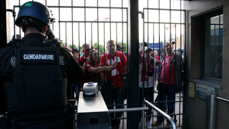 Liverpool fans wait in front of the of the Stade de France prior the Champions League final soccer match between Liverpool and Real Madrid, in Saint Denis near Paris, Saturday, May 28, 2022. (Christophe Ena/AP)