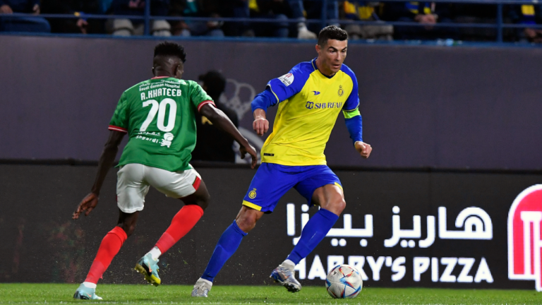Al Nassr's Cristiano Ronaldo, right, fights for the ball against Al Ettifaq's Abdallah Khateeb during the Saudi Pro League match between Al Nassr and Al Ettifaq at Mrsool Park Stadium, in Riyadh, Saudi Arabia, Sunday, Jan. 22, 2023. (AP)