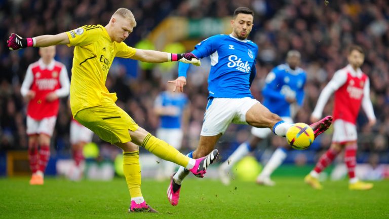 Arsenal's goalkeeper Aaron Ramsdale kicks the ball ahead of Everton's Dwight McNeil during the English Premier League soccer match between Everton and Arsenal at Goodison Park in Liverpool, England, Saturday, Feb. 4, 2023. (Jon Super/AP)