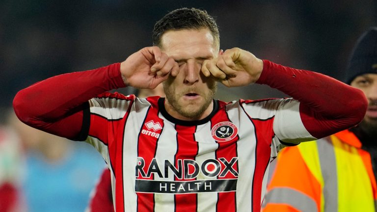Sheffield's Billy Sharp wipes his eyes after the FA Cup 4th round soccer match between Sheffield United and Wrexham at the Bramall Lane stadium in Sheffield, England, Tuesday, Feb. 7, 2023. (Jon Super/AP)