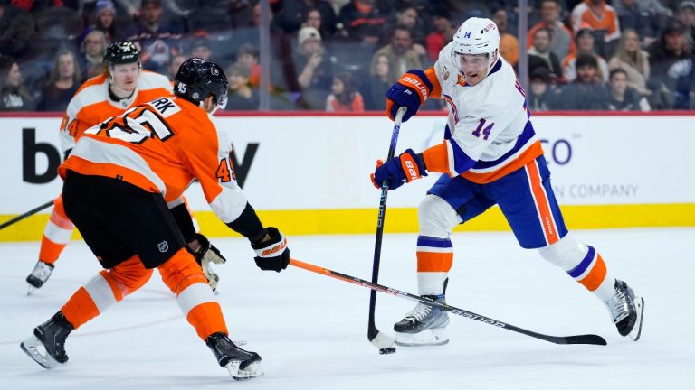 New York Islanders' Bo Horvat, right, shoots the puck against Philadelphia Flyers' Cam York during the first period of an NHL hockey game, Monday, Feb. 6, 2023, in Philadelphia. (Matt Slocum/AP)