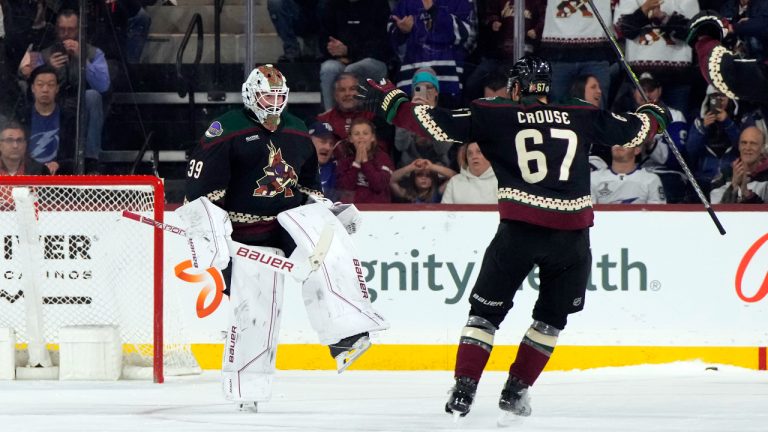 Arizona Coyotes goaltender Connor Ingram celebrates with left wing Lawson Crouse (67) after the team's win over the Tampa Bay Lightning in an NHL hockey game Wednesday, Feb. 15, 2023, in Tempe, Ariz. (Rick Scuteri/AP)