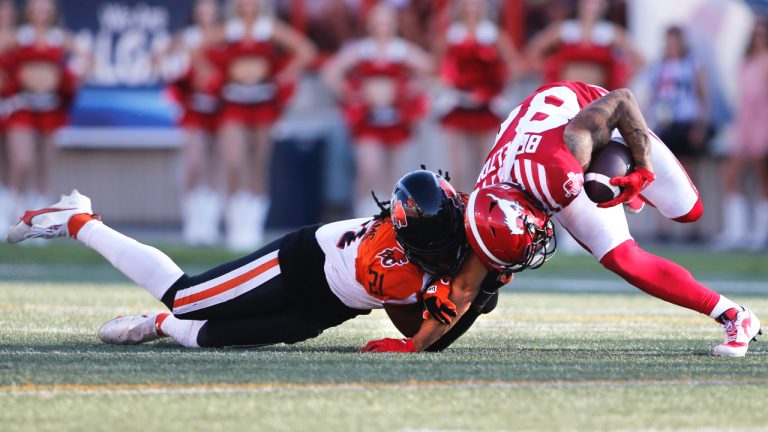 BC Lions linebacker Jordan Williams, left, tackles Calgary Stampeders receiver Reggie Begelton during second half CFL football action in Calgary, Saturday Aug. 13, 2022. (Larry MacDouga/CP)