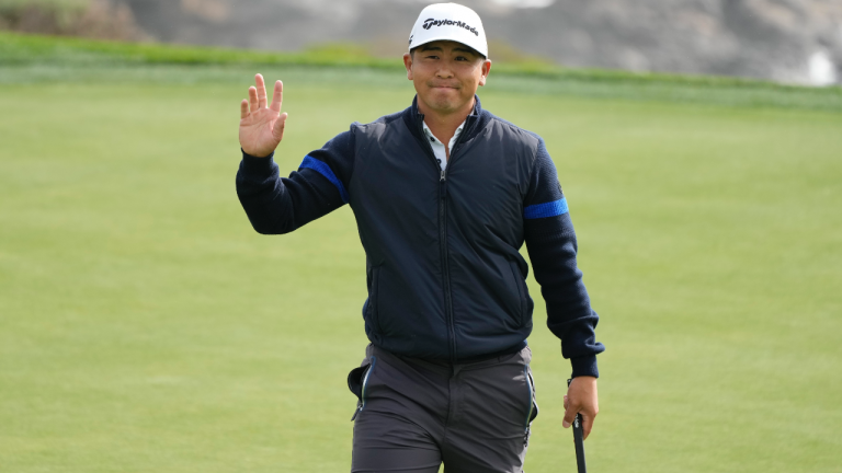 Kurt Kitayama waves after making a birdie putt on the eighth green of the Pebble Beach Golf Links during the second round of the AT&T Pebble Beach Pro-Am golf tournament in Pebble Beach, Calif., Friday, Feb. 3, 2023. (Eric Risberg/AP)