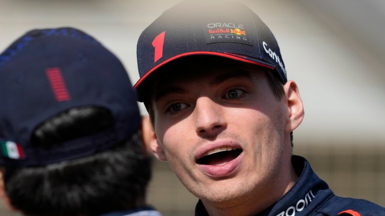 Red Bull driver Max Verstappen of the Netherlands talks to teammate Red Bull driver Sergio Perez of Mexico during the Formula One pre season test at the Bahrain International Circuit in Sakhir, Bahrain, Thursday, Feb. 23, 2023. (AP/Frank Augstein)