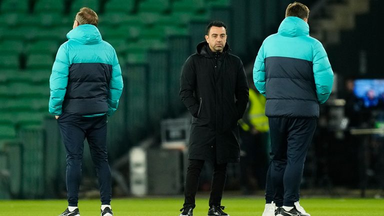 Barcelona's head coach Xavi Hernandez, center, checks the field of the Benito Villamarin stadium ahead of a Spanish La Liga soccer match between Real Betis and Barcelona in Seville, Spain, Wednesday, Feb. 1, 2023. (Jose Breton/AP)