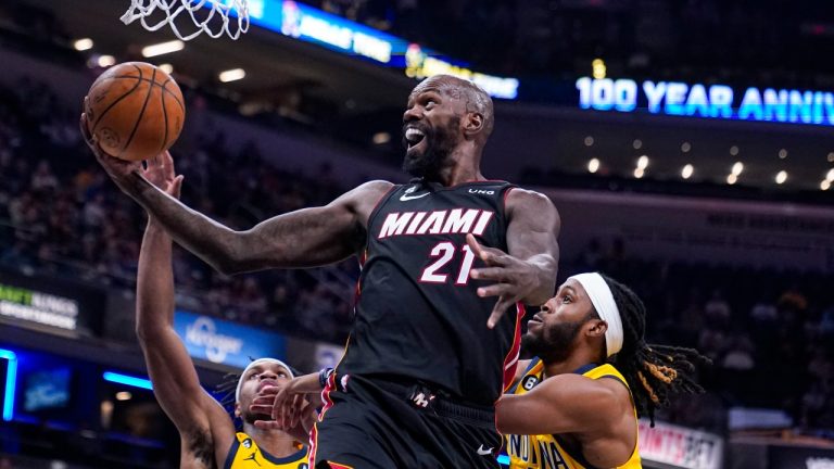 Miami Heat center Dewayne Dedmon (21) shoots in front of Indiana Pacers guard Buddy Hield (24) and forward Isaiah Jackson (22) during the first half of an NBA basketball game in Indianapolis, Friday, Nov. 4, 2022. (Michael Conroy/AP Photo)