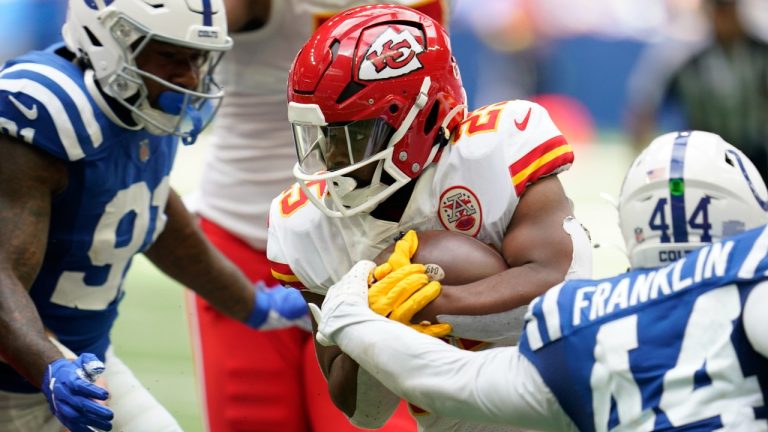Kansas City Chiefs running back Clyde Edwards-Helaire (25) runs against Indianapolis Colts' Yannick Ngakoue (91) and Zaire Franklin (44) during the second half of an NFL football game, Sunday, Sept. 25, 2022, in Indianapolis. (Michael Conroy/AP Photo)