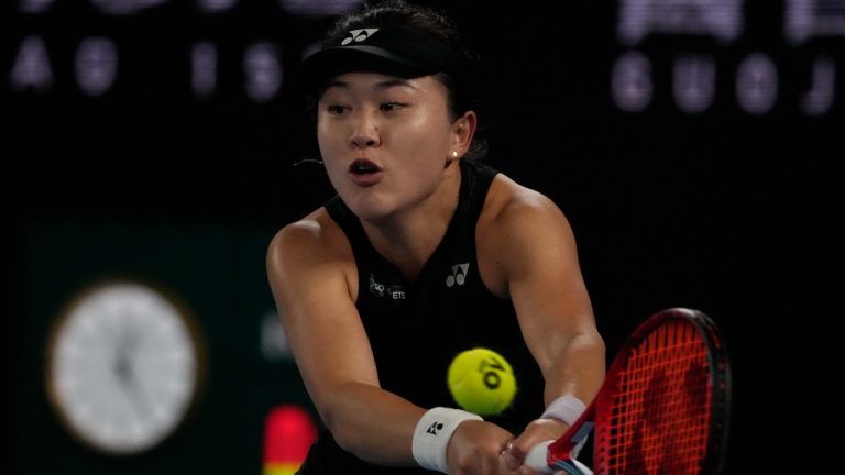 Zhu Lin of China plays a backhand return to Victoria Azarenka of Belarus during their fourth round match at the Australian Open tennis championship in Melbourne, Australia, Monday, Jan. 23, 2023. (Ng Han Guan/AP)