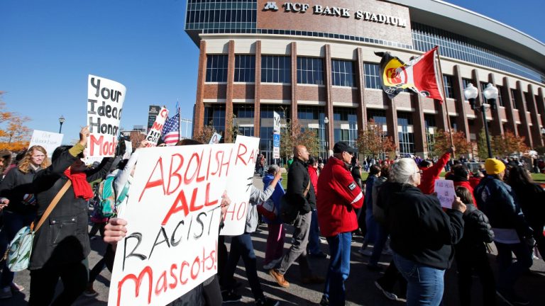FILE - A "No Honor in Racism Rally" marches in front of TCF Bank Stadium before an NFL football game between the Minnesota Vikings and the Kansas City Chiefs, on Oct. 18, 2015, in Minneapolis. The group objects to the Kansas City Chiefs name, and other teams' use of Native Americans as mascots. As the Kansas City Chiefs return to Super Bowl on Sunday, Feb. 12, 2023, for the first time in two years, the movement to change their name and logo will be there again. (Alex Brandon/AP)