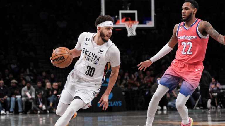 Brooklyn Nets guard Seth Curry, left, drives to the basket against Washington Wizards guard Monte Morris during the first half of an NBA basketball game, Saturday, Feb. 4, 2023, in New York. (Bebeto Matthews/AP)