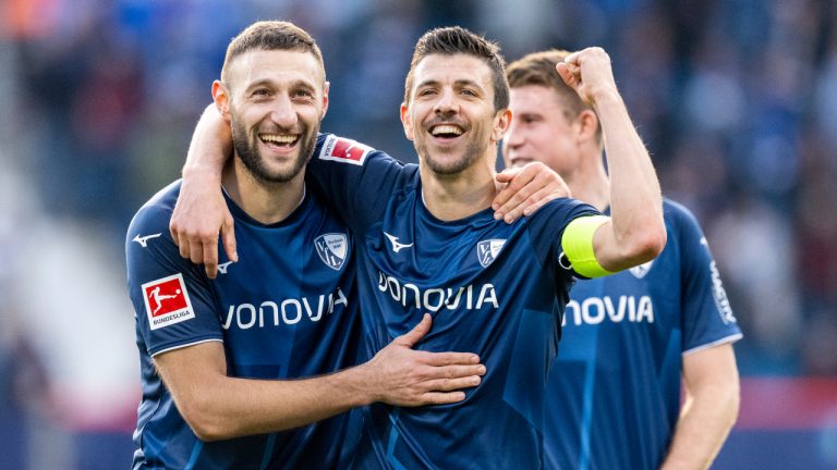 Bochum's Ivan Ordets, left, and Bochum's Anthony Losilla cheer after winning the Bundesliga soccer match between VfL Bochum and RB Leipzig at the Vonovia Ruhrstadion in Bochum, Germany, Saturday March 18. 2023. (David Inderlied/dpa via AP)
