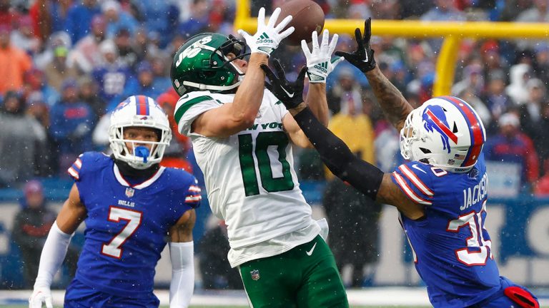 New York Jets wide receiver Braxton Berrios reaches for the ball under pressure from Buffalo Bills cornerback Taron Johnson and Bills cornerback Dane Jackson during the second half of an NFL football game, Sunday, Dec. 11, 2022, in Orchard Park, N.Y. (Jeffrey T. Barnes/AP)