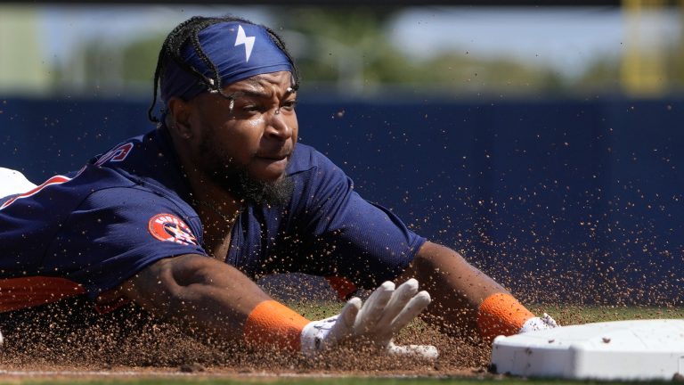 Houston Astros' Corey Julks reaches for third as he dives in for a triple during the second inning of a spring training baseball game against the Miami Marlins Monday, Feb. 27, 2023, in West Palm Beach, Fla. (Jeff Roberson/AP)