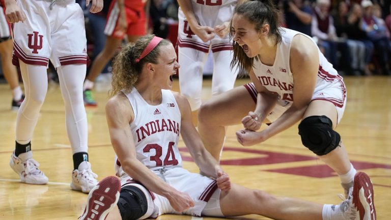 Indiana's Grace Berger (34) reacts with Mackenzie Holmes after Berger took a charging foul during the first half of the team's NCAA college basketball game against Ohio State, Thursday, Jan. 26, 2023, in Bloomington, Ind. (AP Photo/Darron Cummings)