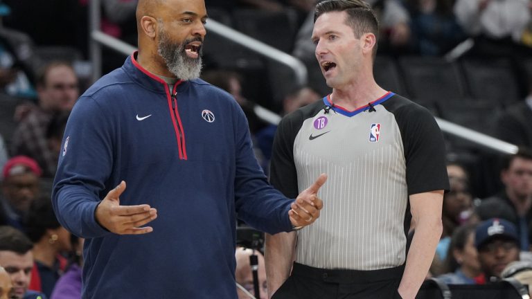 Washington Wizards coach Wes Unseld Jr. talks with referee Ben Taylor during the second half of the team's NBA basketball game against the Charlotte Hornets, Wednesday, Feb. 8, 2023, in Washington. (AP Photo/Jess Rapfogel)