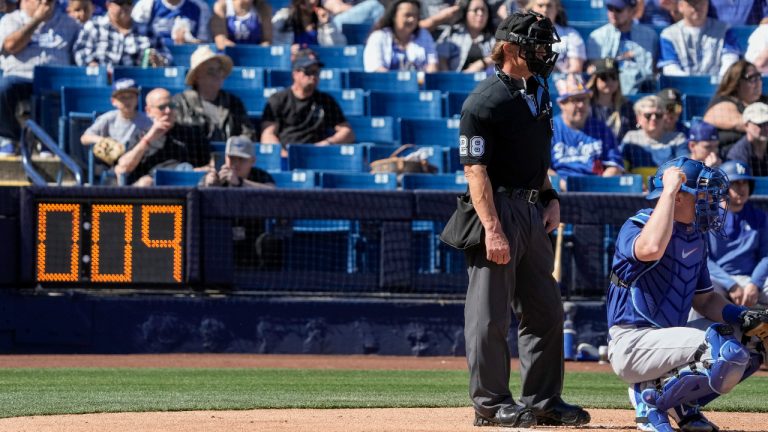 Home plate umpire Jim Wolf waits as the pitch clock counts down during the first inning of a spring training baseball game between the Milwaukee Brewers and the Los Angeles Dodgers Saturday, Feb. 25, 2023, in Phoenix. (Morry Gash/AP)
