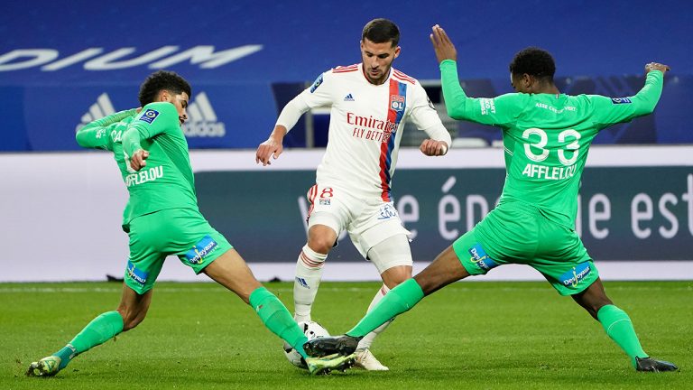 Lyon's Houssem Aouar, center, fights for the ball with Saint-Etienne's Mickael Nade, right, and Saint-Etienne's Mahdi Camara during the French League One soccer match between Lyon and Saint Etienne in Lyon, at the Groupama stadium in Lyon, France, Friday, Jan. 21, 2022.  (Laurent Cipriani/AP)