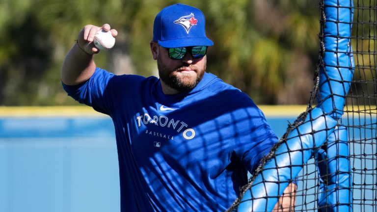 Toronto Blue Jays manager John Schneider pitches at his team’s batting practice during baseball spring training in Dunedin, Fla., on Tuesday, February 14, 2023. (Nathan Denette/CP)